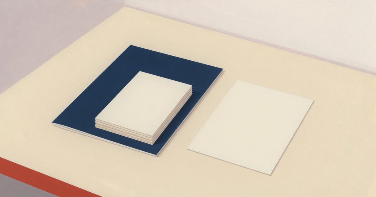 A small stack of blank cream payment stubs on a navy cover, next to a blank postcard.